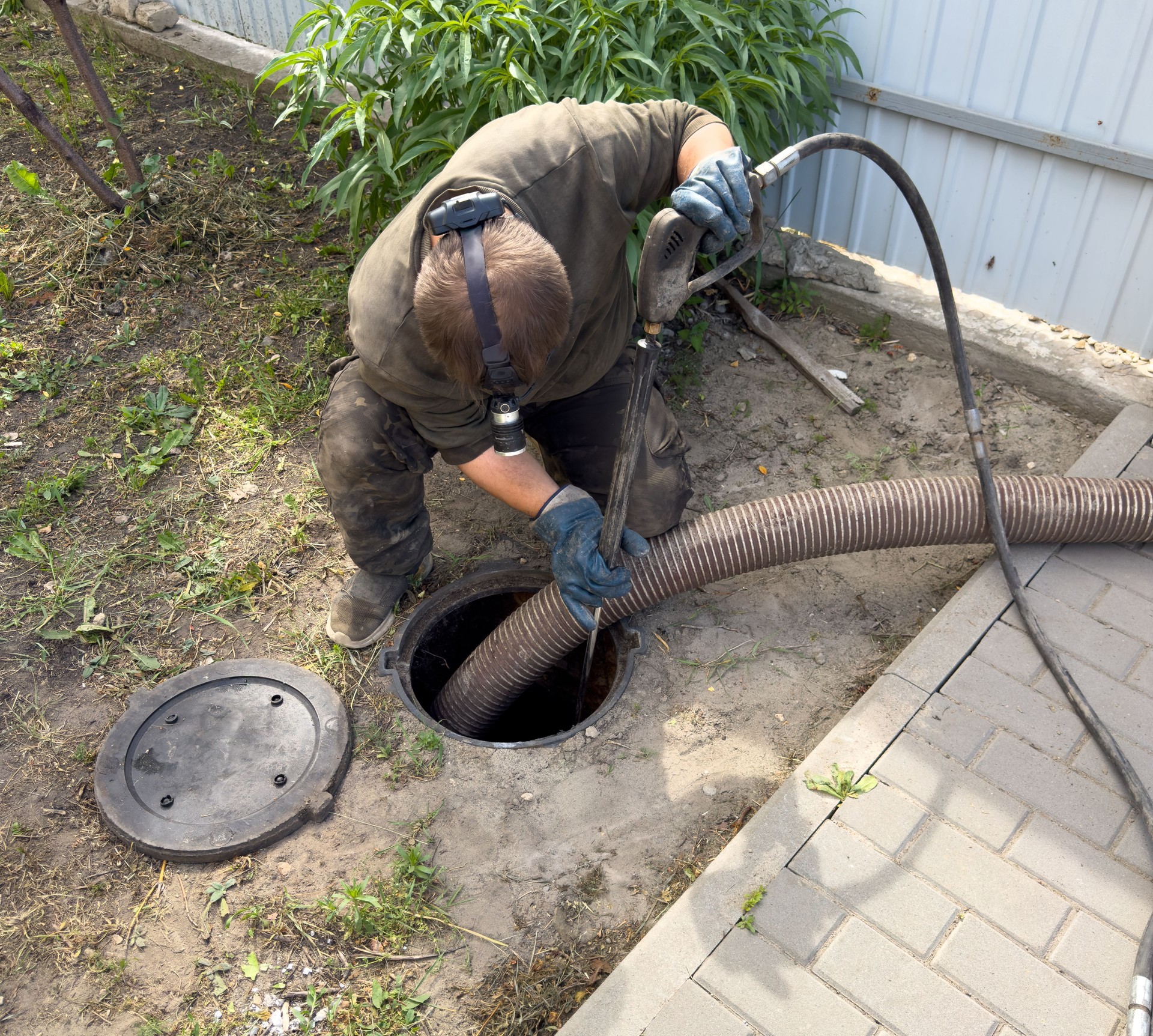 A man is working on a sewer line